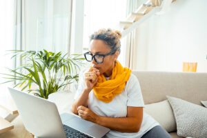 Woman participating in a virtual divorce mediation session from home using a laptop