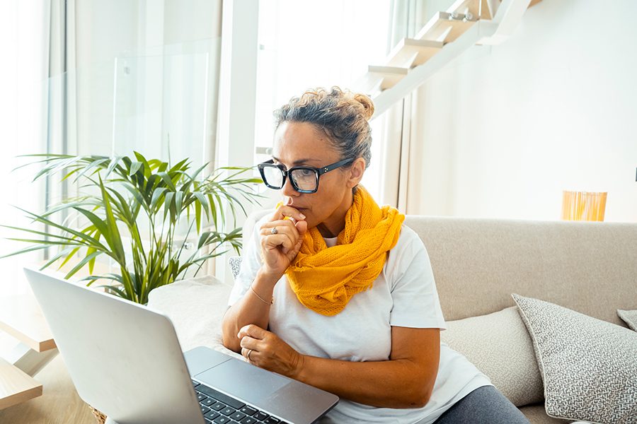 Woman participating in a virtual divorce mediation session from home using a laptop
